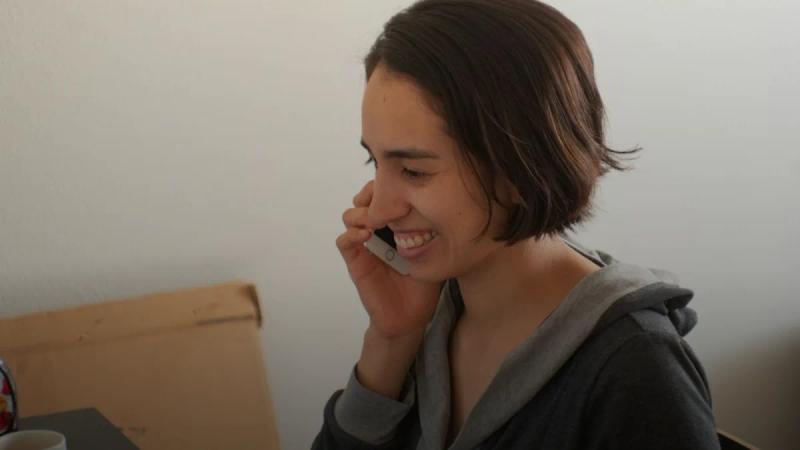 woman in gray hoodie smiling