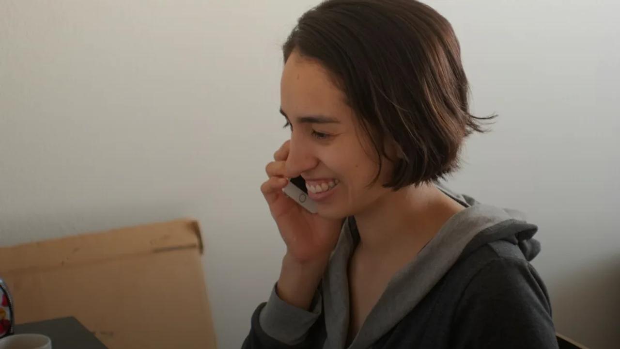 woman in gray hoodie smiling