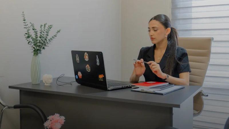 Woman working on a laptop at a desk
