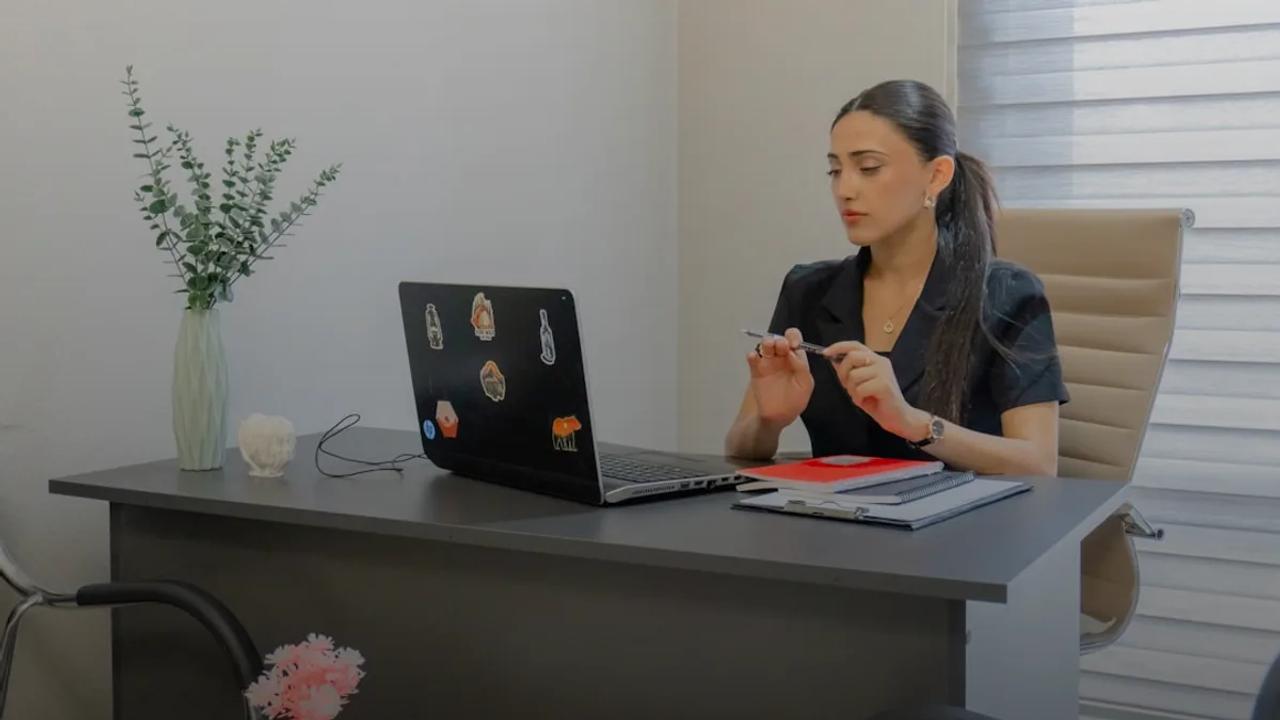 Woman working on a laptop at a desk