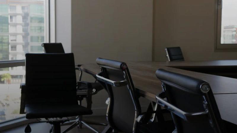 five black rolling chars front of desk