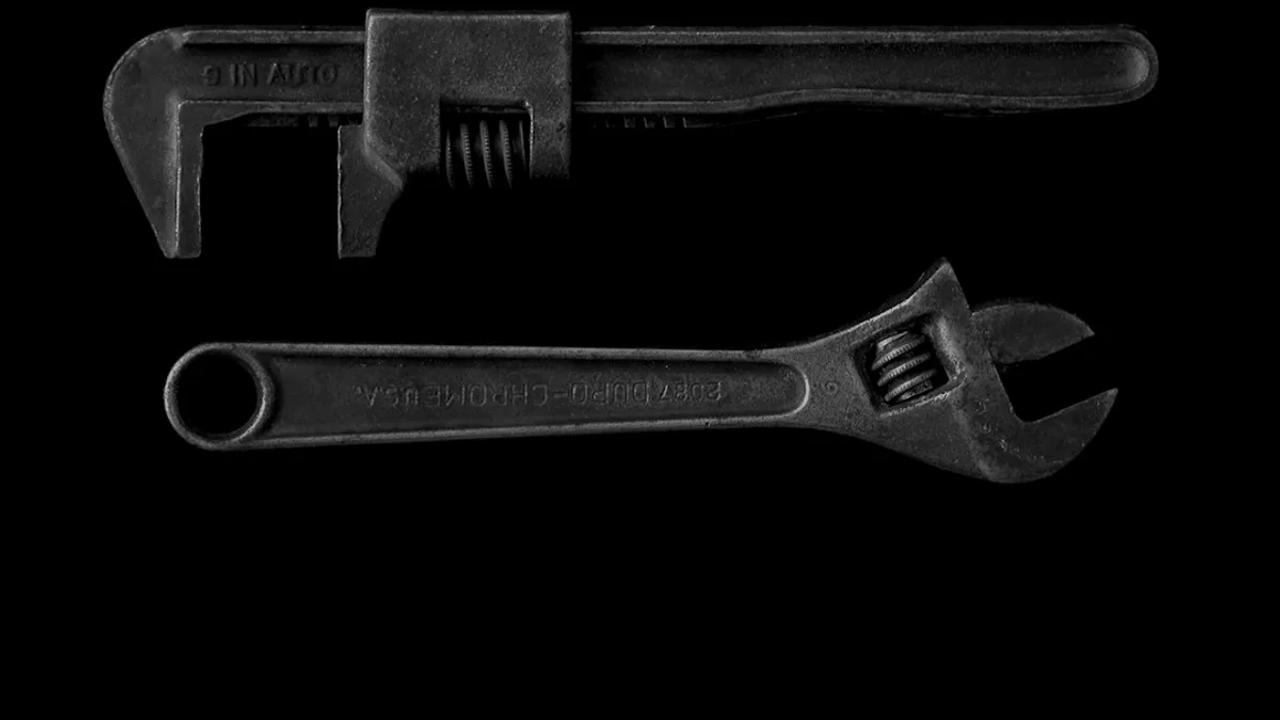 gray adjustable wrench and gray pipe wrench