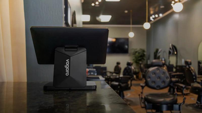 A vagaro pos system on a counter in a barbershop