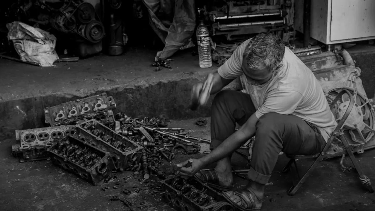 Mechanic working on car engine parts