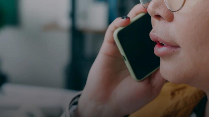 A woman with glasses talking on a cell phone