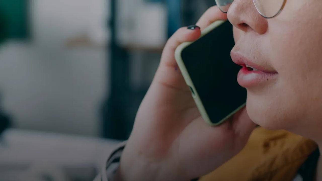 A woman with glasses talking on a cell phone