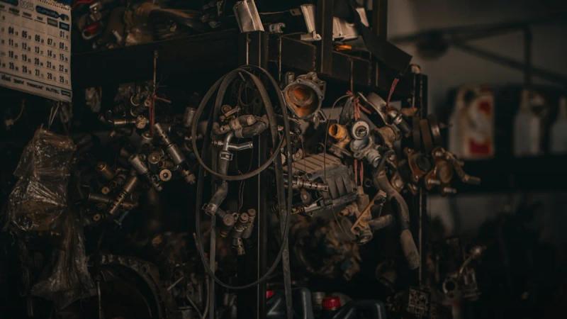 a bunch of engine parts sitting on top of a shelf