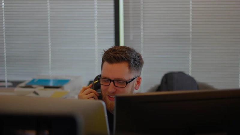 man using IP phone inside room
