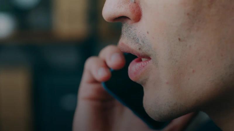 A close up of a person talking on a cell phone