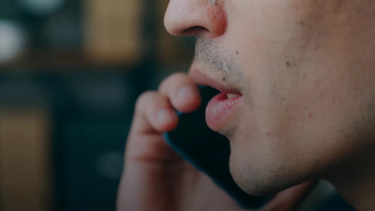 A close up of a person talking on a cell phone