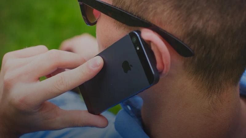 person holding black iPhone 5s