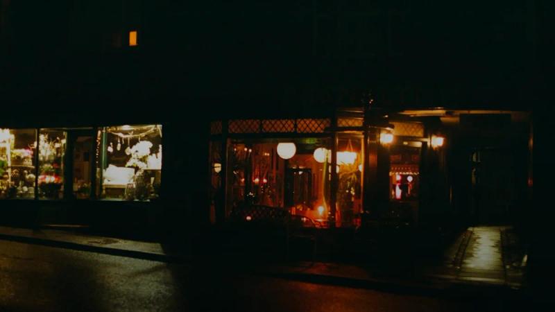 A storefront at night with wet reflections