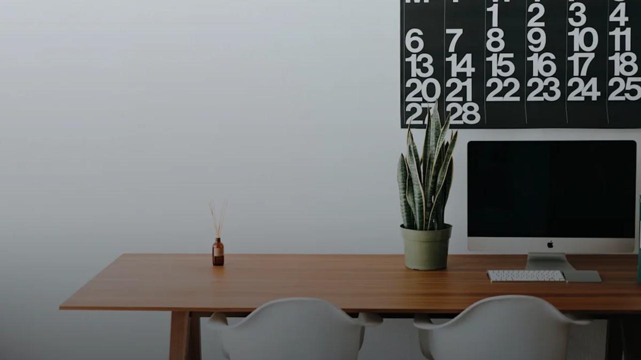 silver iMac on brown wooden desk