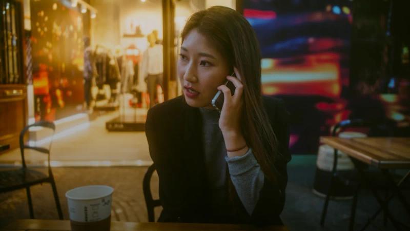 woman talking on phone outdoor in front of store