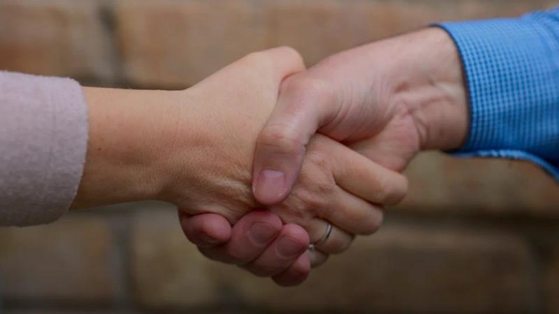 Two people are shaking hands.