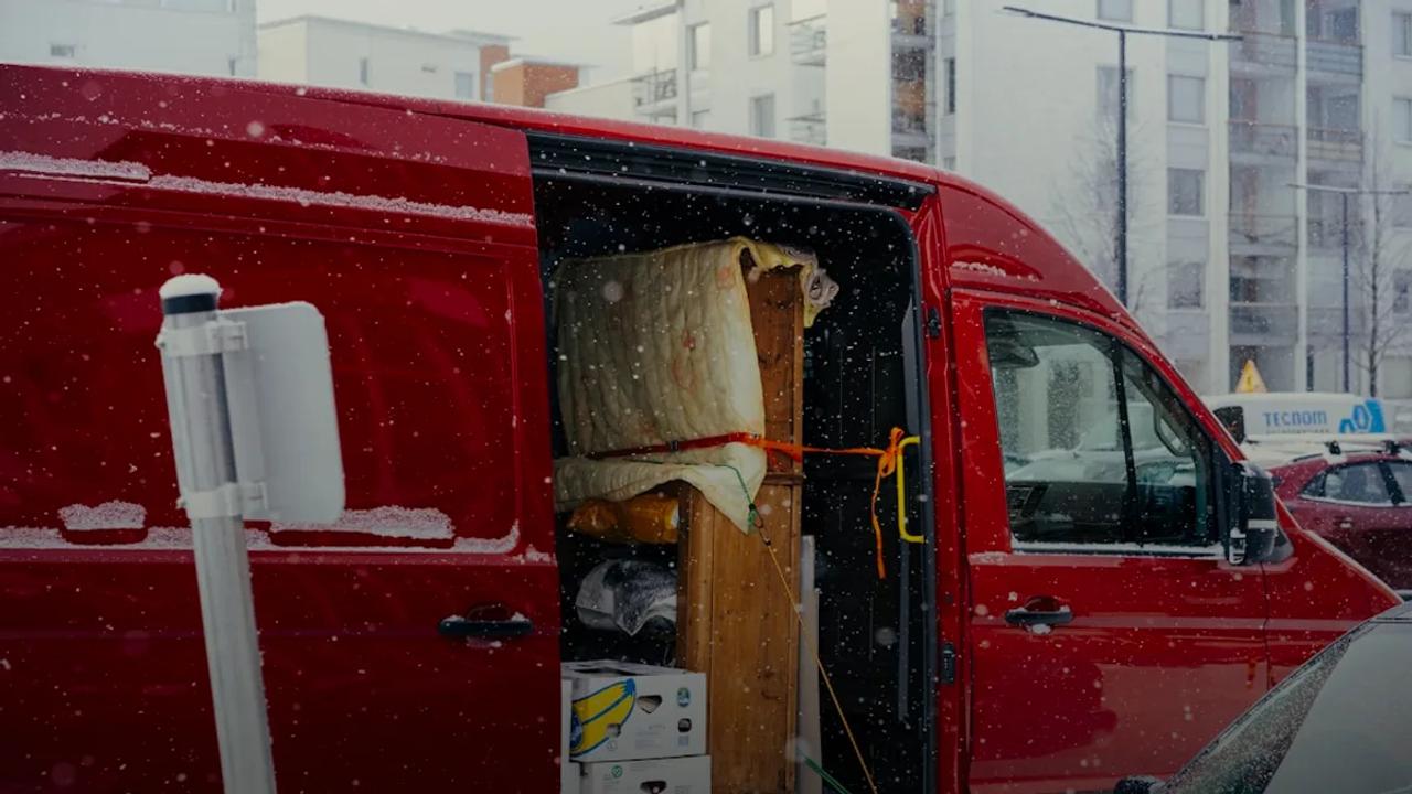 A red van is parked on the side of the road