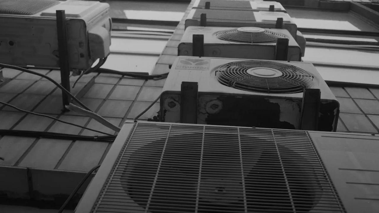 a row of air conditioners sitting on top of a tiled floor