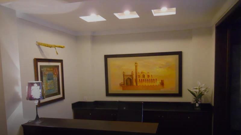 A reception desk with artwork on the wall.