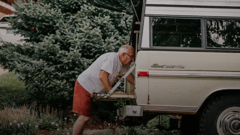 a man is loading something into the back of a van