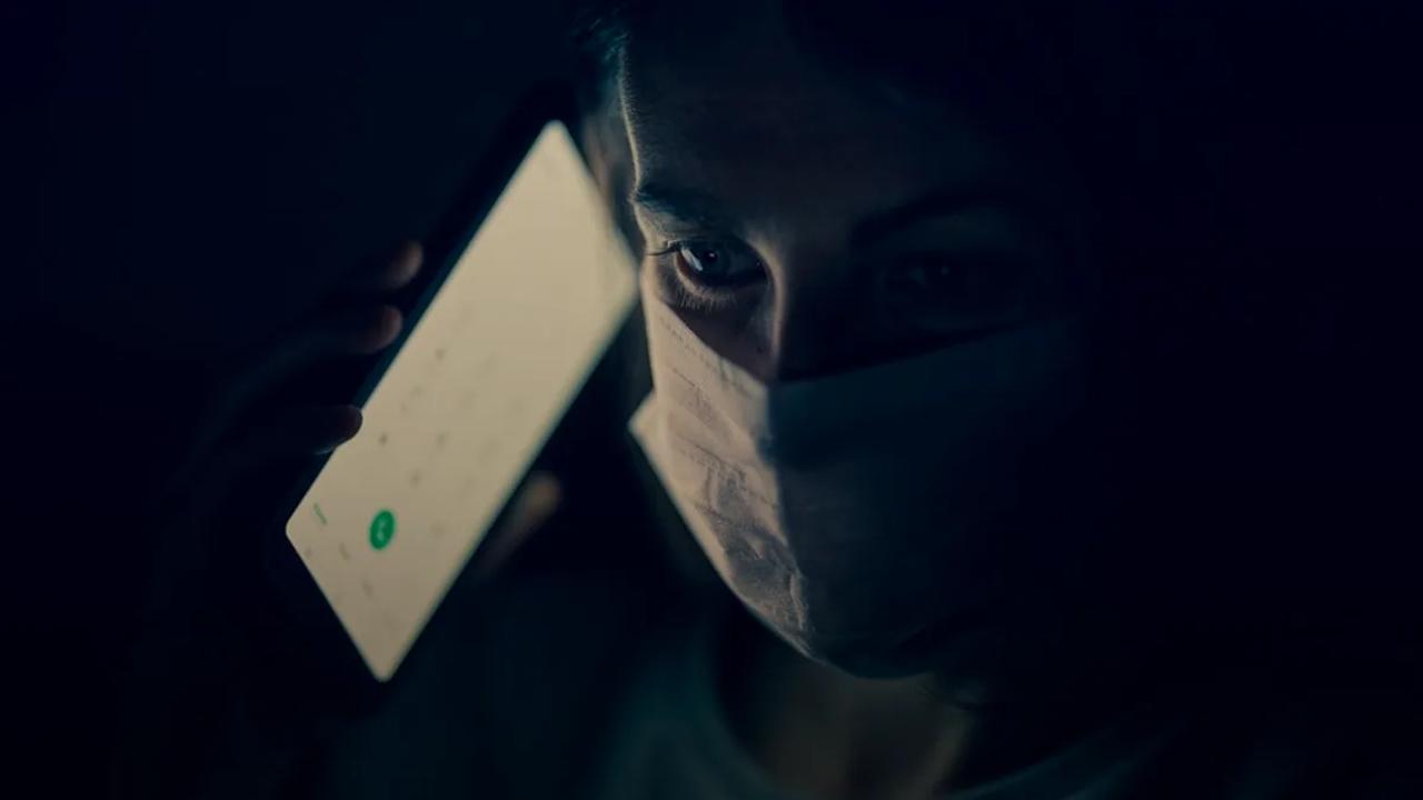 man in white crew neck shirt holding white smartphone
