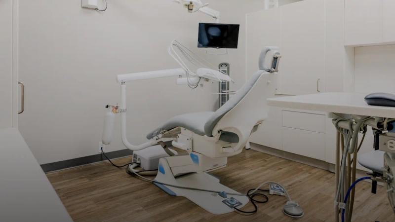a dental room with a desk and chairs