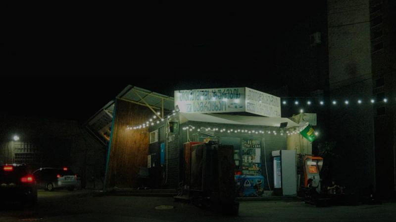 A modern building at night with string lights.